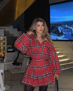 Detail of red plaid skirt and long sleeve shirt set with elegant ruffle design