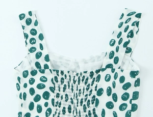 Detail of green polka dot dress showing smocked elastic back and wide shoulder straps