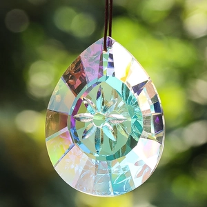 Detailed view of teardrop K9 crystal suncatcher with AB aurora coating and flower engraving