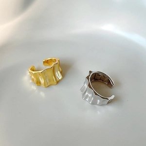 Minimalist C-shaped gear ear cuff set in gold and silver with wave texture