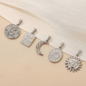 Detailed view of five silver celestial pendants featuring sun, moon and star designs