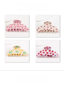 Detail display of fruit patterned hair claws in pink, cream, and lemon yellow styles