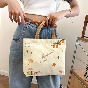 Cream canvas tote bag with autumn harvest prints and khaki handles for daily use