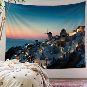 Detail of Santorini sunset wall tapestry featuring blue domes and windmills in a bedroom