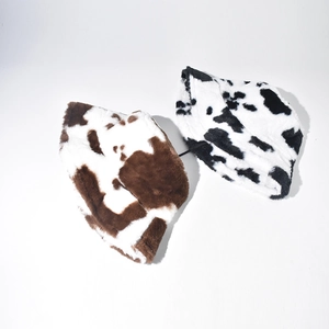 Detailed comparison of brown and black cow print plush bucket hats in soft faux fur