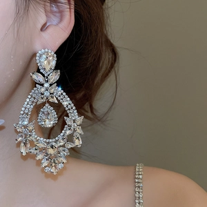 Macro shot of silver-tone teardrop chandelier earrings with sparkling crystal accents