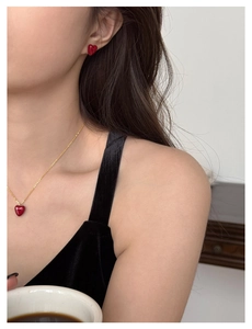 Macro shot of zircon heart earrings and necklace set worn on neck for product detail