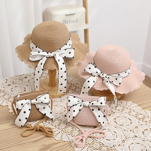 Matching set of straw sun hat and bag with polka dot ribbon bow for women and kids