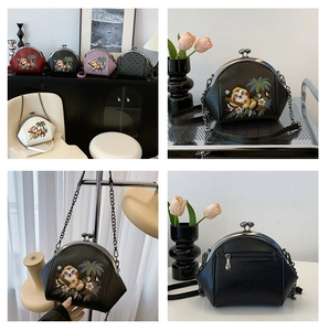 Detailed sloth embroidery and metal kiss-lock closure on retro textured PU leather bag
