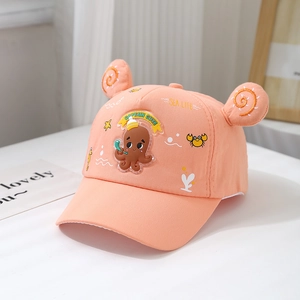 Detail of coral pink kids baseball cap featuring 3D ears and cartoon octopus badge