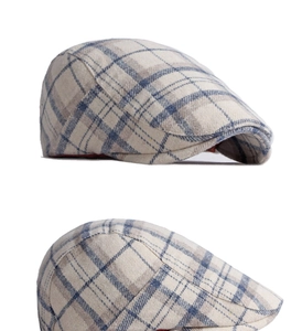 Detailed close-up of wool blend fabric and classic plaid pattern on the flat cap