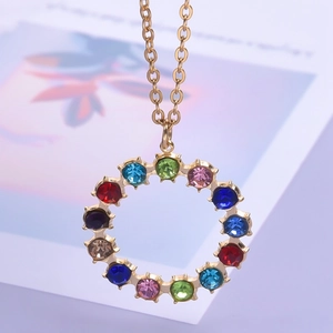 Macro view of 18k gold plated round pendant with twelve colorful crystals on a thin chain