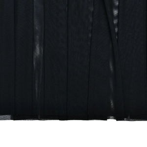 Close-up of black mesh fabric texture showing fine weave and transparency of the dress