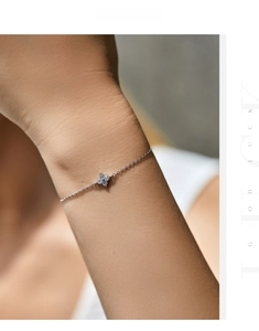Detailed close-up of a delicate S925 silver four-leaf clover bracelet with sparkling stones