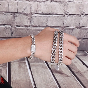 Detailed view of silver polished Cuban link bracelet and necklace with diamond-set clasp