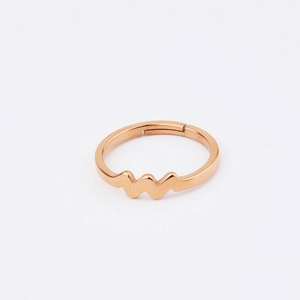Detail of rose gold stainless steel ring featuring a minimalist heartbeat wave pattern