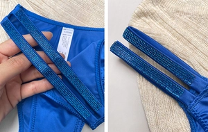 Detail of blue ice silk thong with double rhinestone straps and care label showing S size