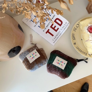Detail of plush mini makeup bags with sozakka embroidery and textured faux mohair fabric