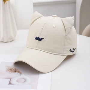 Cute beige baseball cap with 3D cat ears and blue embroidery on a minimalist background
