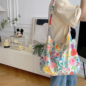 Spacious floral canvas tote bag shown by a model in a bright home setting for daily wear