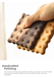 Macro shot of handcrafted walnut biscuit coaster showing fine wood grain and texture