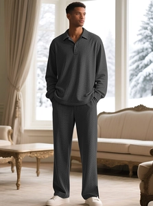 Men's dark gray lounge set with jacquard texture and polo collar against snowy window