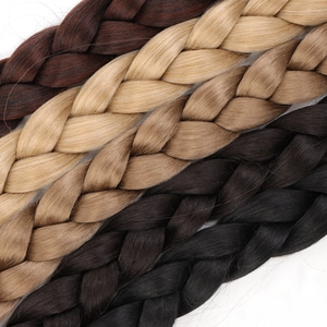 Close-up of four-strand braided hair extensions in dark brown, gold, light brown, and black