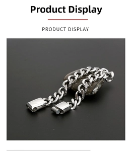 Polished stainless steel Cuban link bracelet with magnetic buckle on a stone background