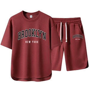 Flat lay of red men's sportswear set with Brooklyn New York print on T-shirt and shorts
