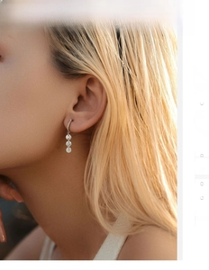 Macro view of S925 sterling silver drop earrings with three round sparkling crystals