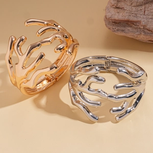 Irregular geometric multilayer metal cuff bracelets in polished gold and silver finishes