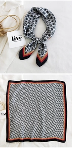 Detailed view of floral pattern silk scarf with elegant contrast border and silky luster
