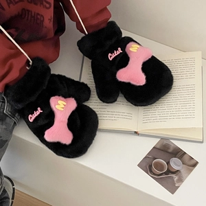 Cute black plush gloves with pink bone patch and M letter embroidery on cozy book background
