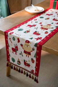 Detail of Christmas table runner with jacquard holiday patterns and luxury tassels
