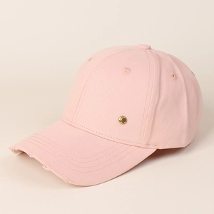 Detail of pink cotton baseball cap with distressed brim and golden metal H letter logo
