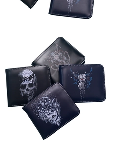Close-up of multiple black men's short wallets with various skull prints in a group shot