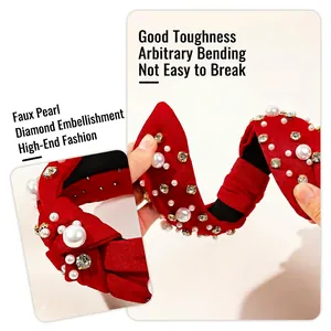 Christmas red knotted headband with pearls and rhinestones shown in flexible durability test