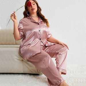 Lustrous pink satin pajama set with button-up short sleeve top and long pants for women