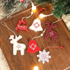 Handcrafted wooden Christmas tree ornaments with wool accents in deer and snowflake shapes