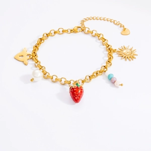 Detail of stainless steel bracelet featuring strawberry, sun face, and winged heart charms