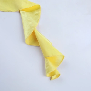 Detailed close-up of vibrant yellow satin fabric with reinforced stitched edge and fine texture