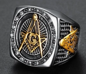 Detailed close-up of a two-tone Freemasonry signet ring with cubic zirconia accents