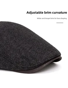 Close-up of a wide foldable brim on a men's winter newsboy hat in grey wool fabric