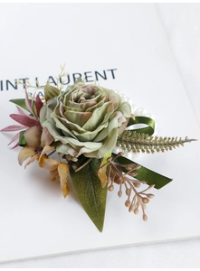 Detail of vintage dusty green rose wrist corsage with pearls and silk ribbon ties