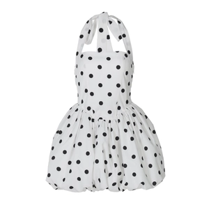 Detail of vintage white polka dot halter neck dress with tied back and cinched waist