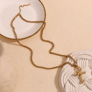 Detail of 18K gold-plated snake pendant with sparkling stones on thick rope chain