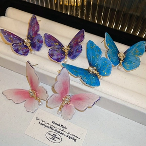 Elegant butterfly stud earrings set with crystal rhinestones and white hanging pearls