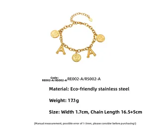 Detailed view of 18K gold plated stainless steel letter A and queen coin charms bracelet