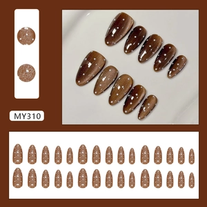 Cat eye coffee press-on nails with white polka dots and elegant glossy finish