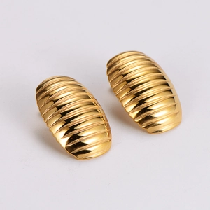 Detailed close-up of gold-plated oval stud earrings with textured striped spiral patterns
